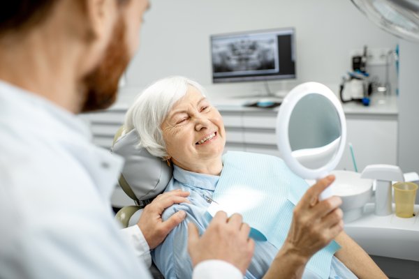 man smiling in dentists chair