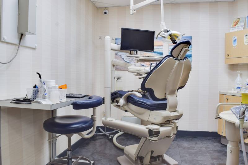 man smiling in dentists chair