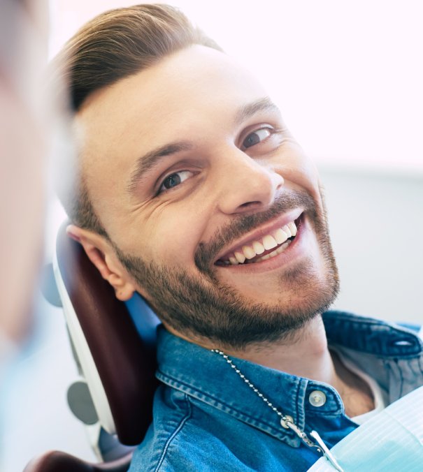 man smiling in dentists chair